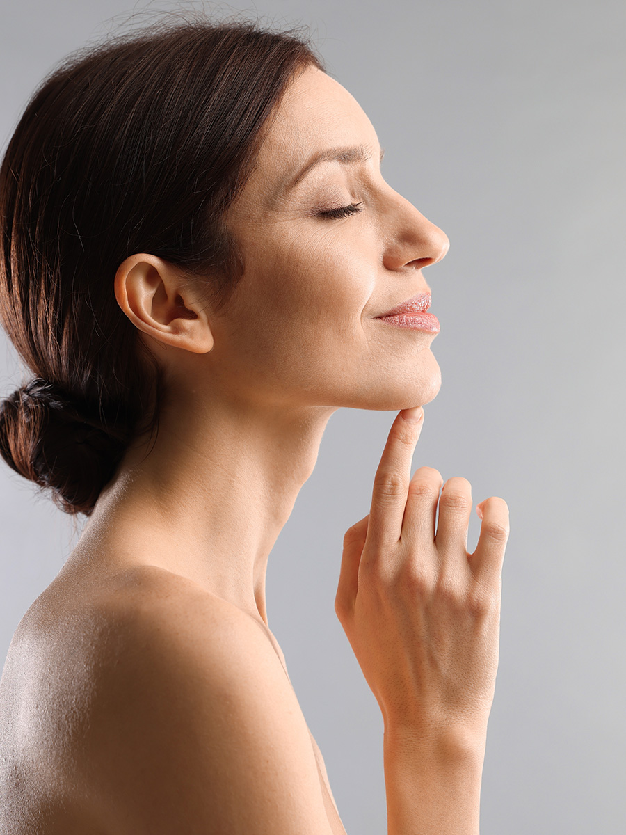 Profile of a woman touching her chin